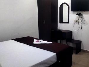 Ένα ή περισσότερα κρεβάτια σε δωμάτιο στο All Seasons Guest House