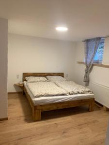 a bedroom with a wooden bed in a room at Thaya-Auszeit in Thaya