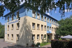 a large white building with a sign on it at Pension Bertramshof in Wismar