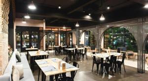 a dining room with tables and chairs and windows at Verona Boutique Hotel - The Verona Co., Ltd in Ban Wang Khon Daeng