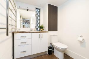 Un baño blanco con inodoro y lavabo. en Artful Kingston Stay with Personal Touch - Hosted by Canstay, en Kingston  25 fotos más