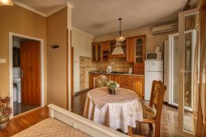 a kitchen with a table with a vase on it at Helena in Mlini