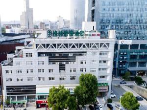 a large white building in the middle of a city at GreenTree Inn Zhangjiagang Yangshe Old Street Stadium in Zhangjiagang