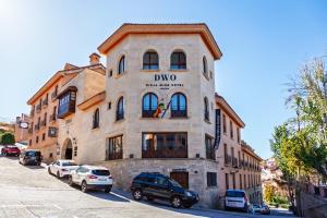 a building with cars parked in front of it at DWO Rioja Wine Hotel in Cenicero