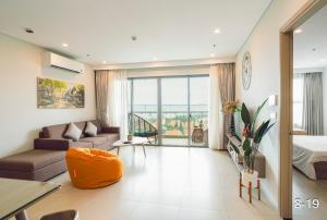 a living room with a bed and a couch at The Sóng Vũng Tàu Apartment in Vung Tau +63 photos