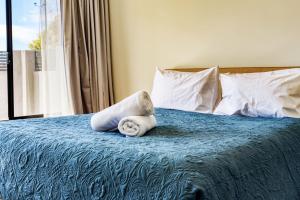 a bedroom with a bed with a towel on it at Casa Al Mare in Busselton