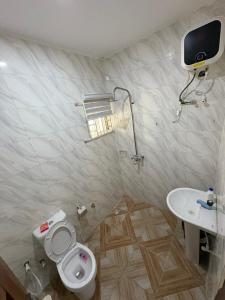 a bathroom with a toilet and a sink at Bollington ADEX house 