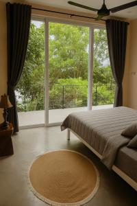 a bedroom with a bed and a large window at NEW! Sunset & Seaview Pool Villa in Ko Ma +26 photos
