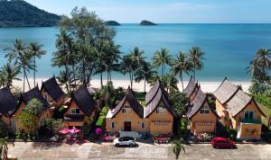 a resort on the beach with palm trees and the ocean at Tankini Beachfront Villa in Ban Khlong Son
