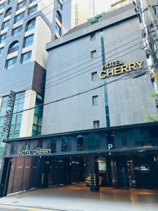 a building with a sign for the hotel cheney at Hotel Cherry in Seoul