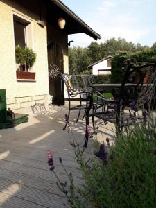 a bench sitting on a deck next to a building at Bungalow am Silbersee in Kittlitz +9 photos