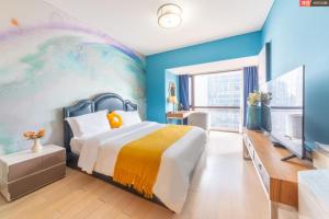 a bedroom with a large bed with a painting on the wall at Qingdao Tinglan Hotel Apartment (Wusi Square Mixc City Branch) in Qingdao