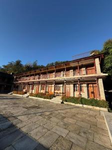 a large building with a lot of windows at RJ Boutique Hotel - Ghandruk in Astam +11 photos