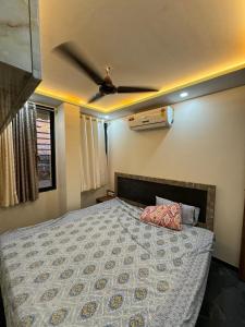 a bedroom with a bed with a ceiling fan at Vijay Cozy Corner Hostel in Navi Mumbai +30 photos