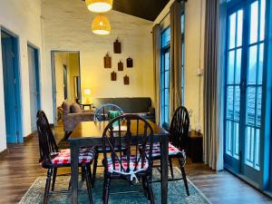 a dining room with a table and chairs at Faraway Cottages, Auli in Joshīmath +130 photos