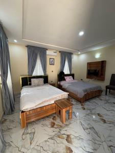 a bedroom with two beds and a tv in it at Bollington ADEX house 