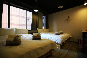 Postel nebo postele na pokoji v ubytování NYS Loft Hotel
