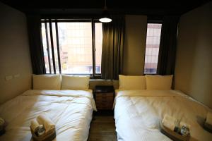 Postel nebo postele na pokoji v ubytování NYS Loft Hotel