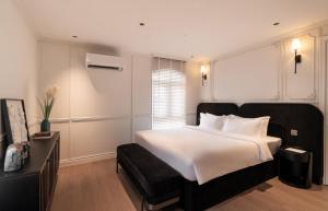 Postel nebo postele na pokoji v ubytování AMANA Boutique Hotel - Than Van Nhiep