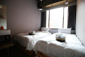 Postel nebo postele na pokoji v ubytování NYS Loft Hotel
