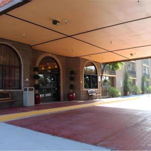 a large building with an open roof with a patio at Alhambra Hotel in Alhambra