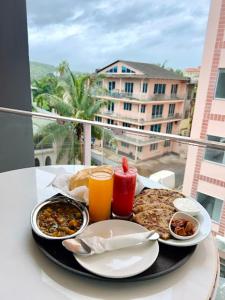 a tray of food on a table on a balcony at Amigos Candolim Beach in Candolim