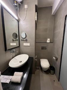a bathroom with a sink and a toilet at Amigos Candolim Beach in Candolim