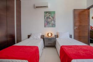 two beds sitting next to each other in a room at Tranquil hideaway with breathtaking sea views in Kissonerga