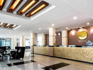 a lobby of a hotel with a reception desk at The Rich Residence in Ban Tha Kup