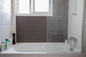 a bathroom with a shower with a tub and a window at Tranquil hideaway with breathtaking sea views in Kissonerga +19 photos