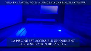 a room with a swimming pool in a blue room at Le Margaret Holidays in La Plaine des Cafres