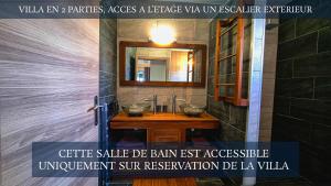a bathroom with a sink with a mirror and a counter at Le Margaret Holidays in La Plaine des Cafres