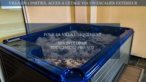 a blue tub filled with water with a sign at Le Margaret Holidays in La Plaine des Cafres +23 photos