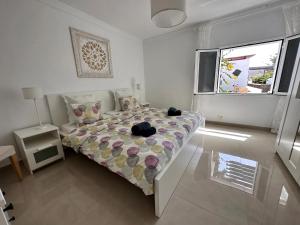 a bedroom with a bed with a cat sitting on it at Villa Sol in Charco del Palo