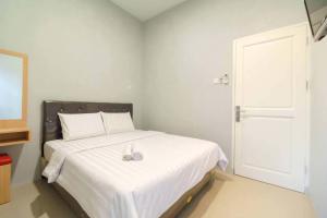 Ένα ή περισσότερα κρεβάτια σε δωμάτιο στο Hotel Idayu Natuna Palembang RedPartner