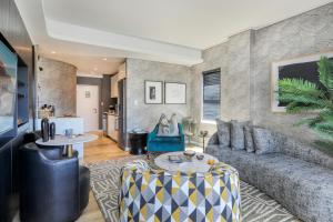 a living room with a couch and a table at Danbury on Loop - Designer Apartment in Cape Town in Cape Town
