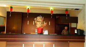 a man standing behind a counter in a restaurant at Hotel Bintang in Palur