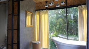 a bathroom with a tub and a large window at Near beach hostel in Bang Tao Beach