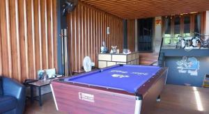 a room with a pool table in a room at Near beach hostel in Bang Tao Beach