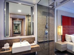 a bathroom with a sink and a shower at Grand Mercure Jakarta Harmoni in Jakarta