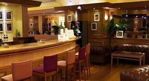 a bar in a restaurant with purple chairs at Zaozhuang Hotel in Zaozhuang