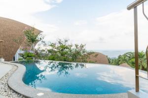 a swimming pool in the middle of a yard at Villa Azure in Koh Samui 
