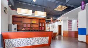 a restaurant with a bar in a room at Oriental Hotel in Dongguan