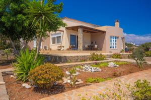 a house with a garden and a swimming pool at Villa Thea in Agios Nikolaos