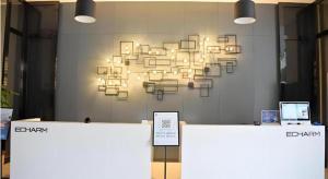 a chandelier hanging on a wall in a room at Echarm Hotel Beihai Railway Station in Dianbailiao