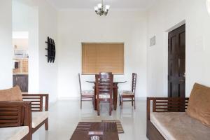 a living room with a table and chairs at 1bhk Premium BS1 - Candolim Calangute Area in Candolim