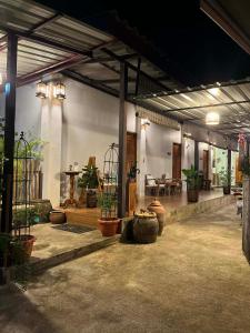 a large room with potted plants in a building at OldTown Boutique House Sukhothai in Sukhothai