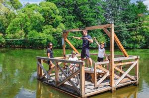 a group of people standing on a wooden bridge in the water at Thaya-Auszeit in Thaya