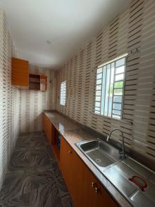 a kitchen with a sink and a window at Bollington ADEX house 