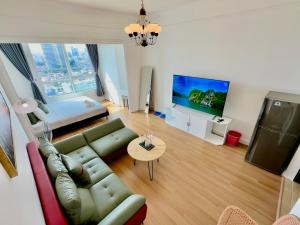 a living room with a couch and a tv at Diny Aparthotel - Rooftop Pool - The Manor 2 in Ho Chi Minh City
